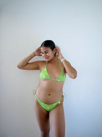 Dive into tranquil elegance with our 'Mar Espejo' bikini, the Spanish term for Ocean Mirror. Crafted in vibrant green with dainty white flower, this bikini captures the serene beauty of water, where the ocean reflects the sun like a shimmering mirror. Perfect your summer swimwear staples with this print in the rotation!