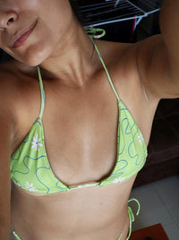 Dive into tranquil elegance with our 'Mar Espejo' bikini, the Spanish term for Ocean Mirror. Crafted in vibrant green with dainty white flower, this bikini captures the serene beauty of water, where the ocean reflects the sun like a shimmering mirror. Perfect your summer swimwear staples with this print in the rotation!
